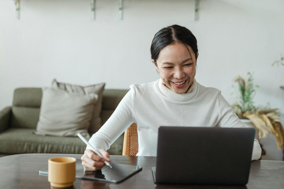 A lady from the Philippines is working remotely on her laptop.